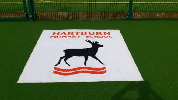hartburn primary school white logo cut into playground surface