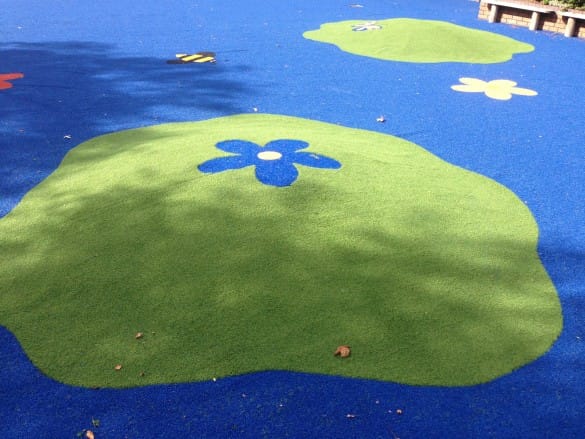 blue and green nursery area with green artificial hills and flower design