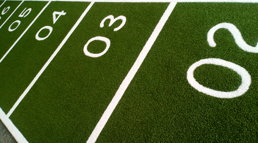 number markings on artificial grass performance track in green and white