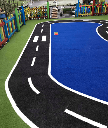 astro turf playground with road