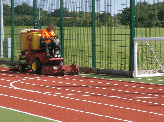 maintenance machine cleaning the side of the pitch