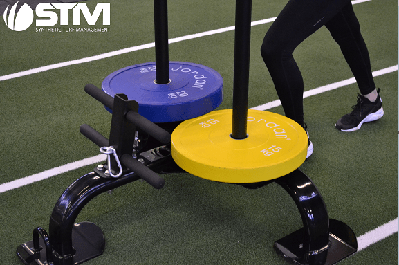 close up image of sled being pushed on track with plates