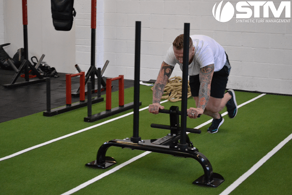 man pushing gym sled