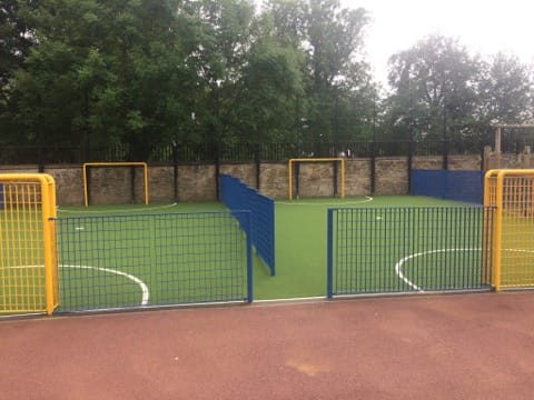 image of both mugas separated by a small blue metal fence