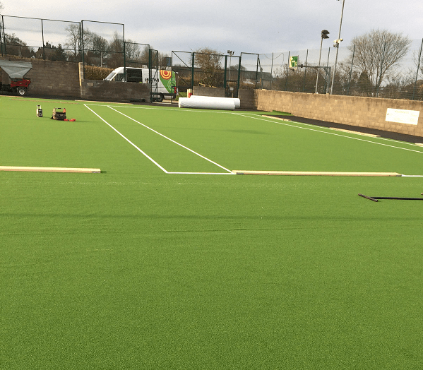 artificial turf muga installation- cutting the lines in