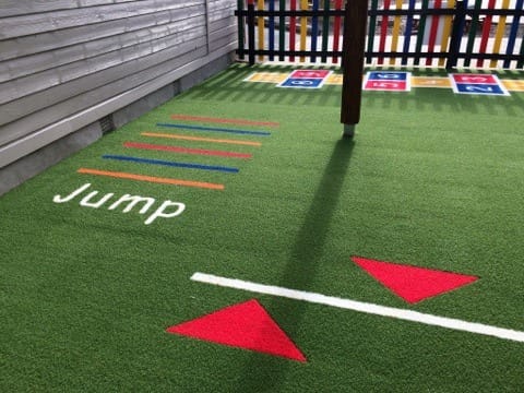 hopsotch and jump line in colourful synthetic turf 
