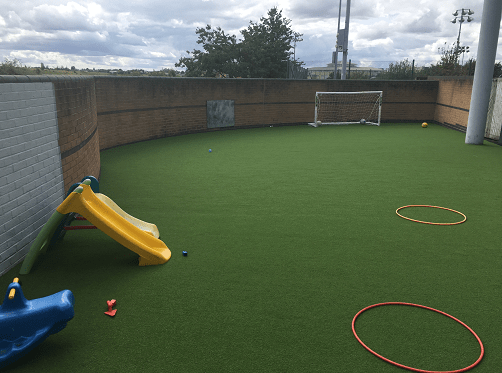 play area with slide and football goal
