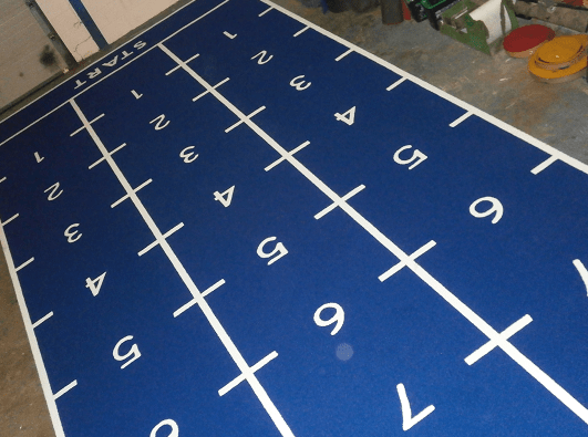 blue sled track gym flooring showing numbers in white cut in