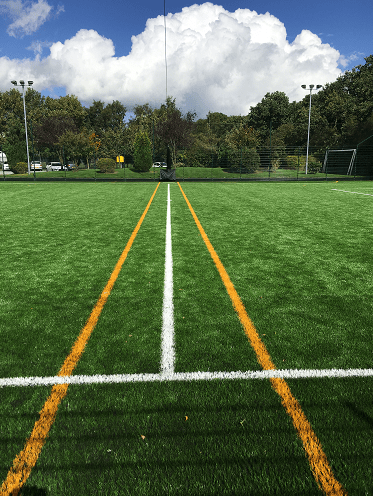 synthetic football pitch middle markings white centre line and yellow 5 a side lines