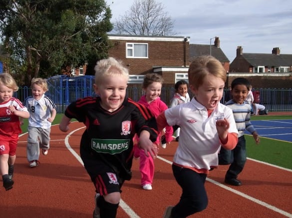 pupils running on artificial turf running track