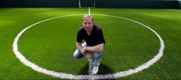 alun armstrong stood in the middle of th 3g football pitch