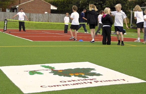 Oakridge Primary School MUGA logo mat with children playing
