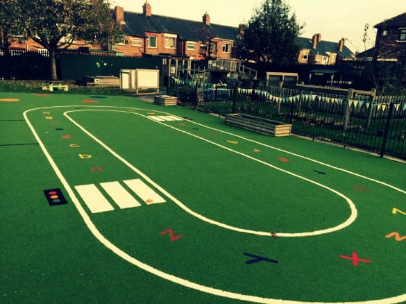 playground roadway with synthetic grass