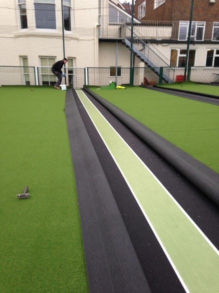 cutting the artificial turf and gluing seems together