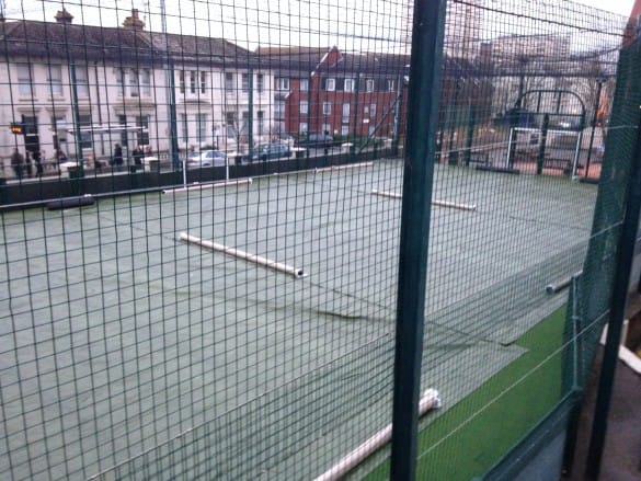 view from behind fencing looking onto concrete surface