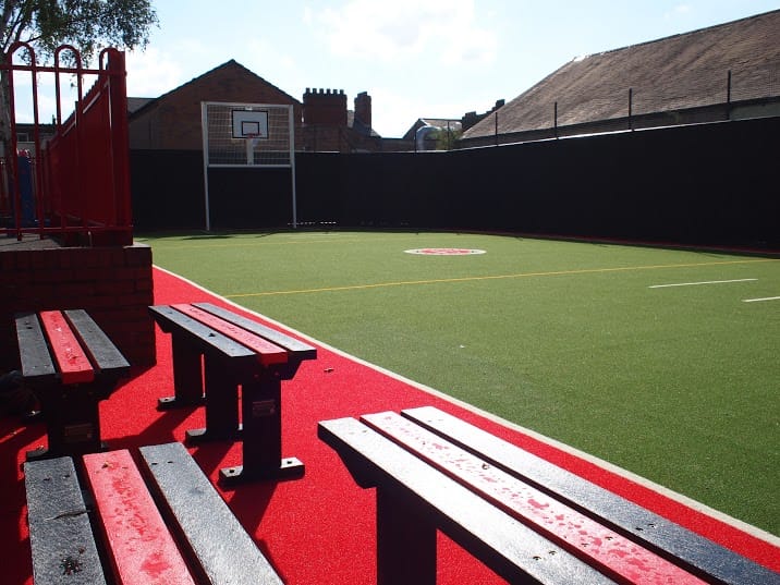 View from seating area onto St Savious Green MUGA with red border