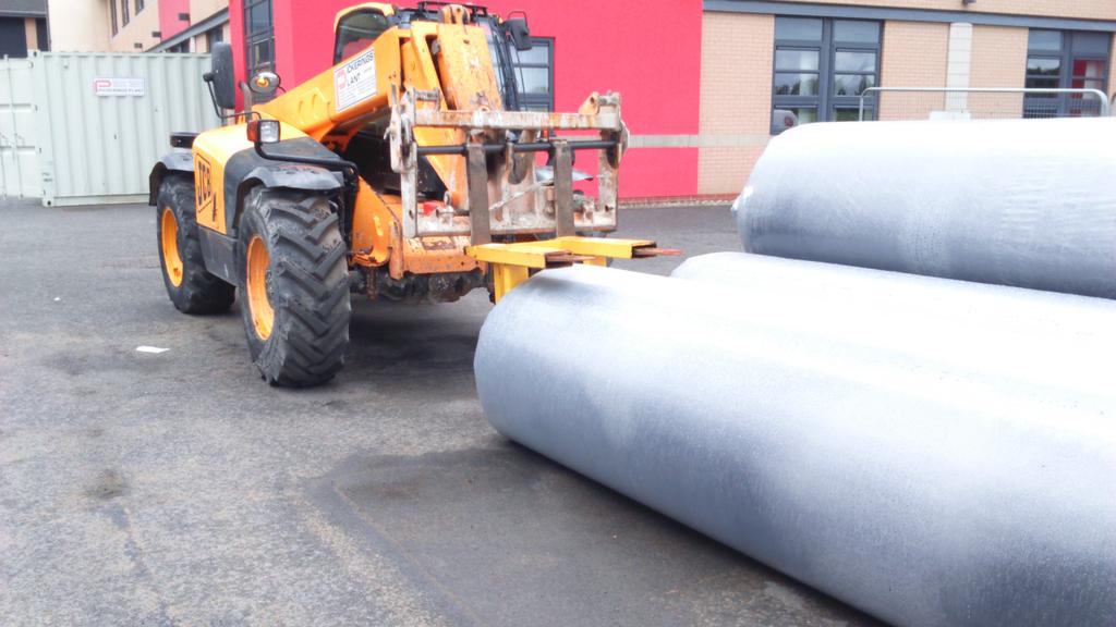 transporting artificial turf rolls to site