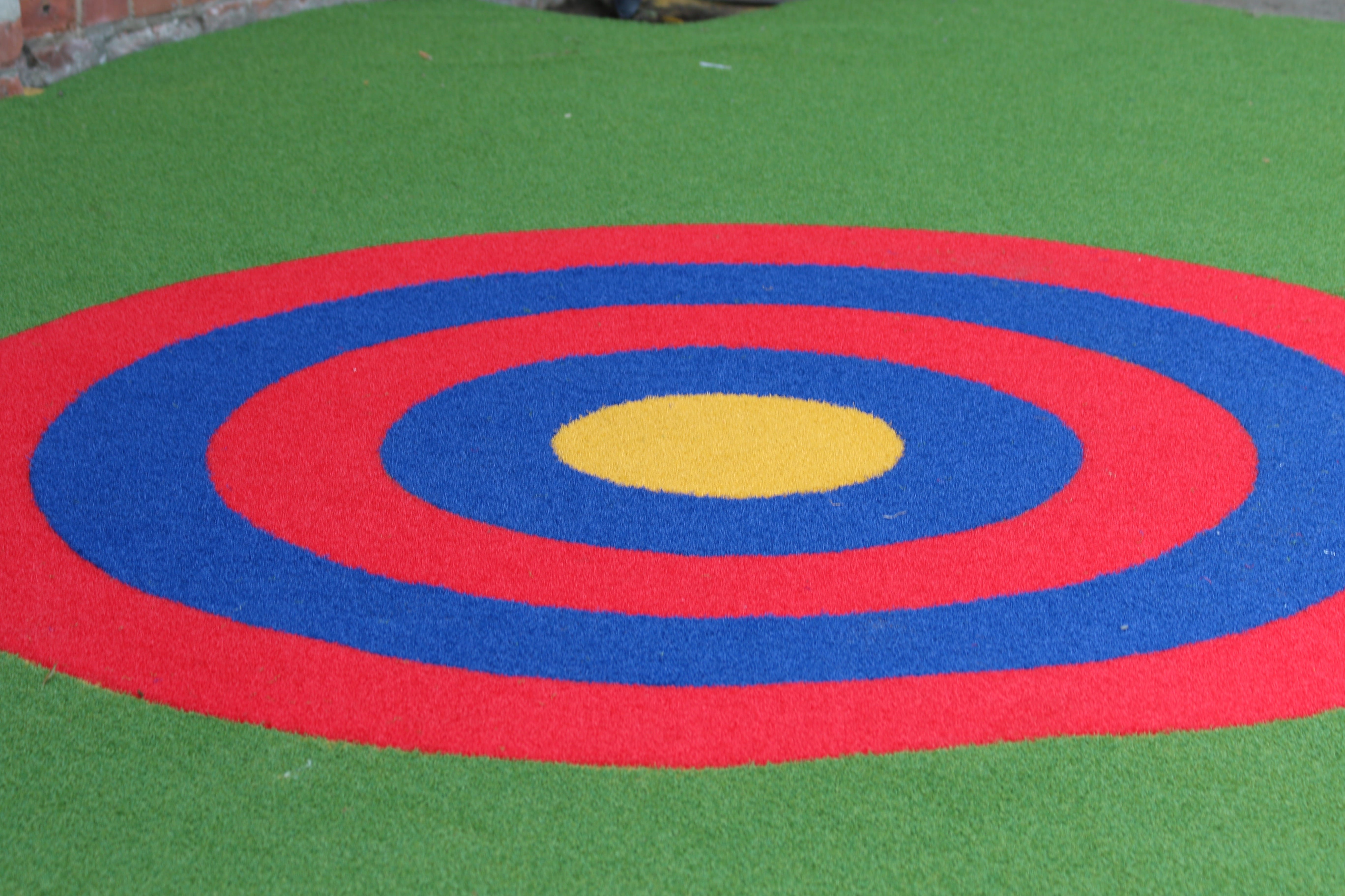 Red, blue and yellow artificial grass target