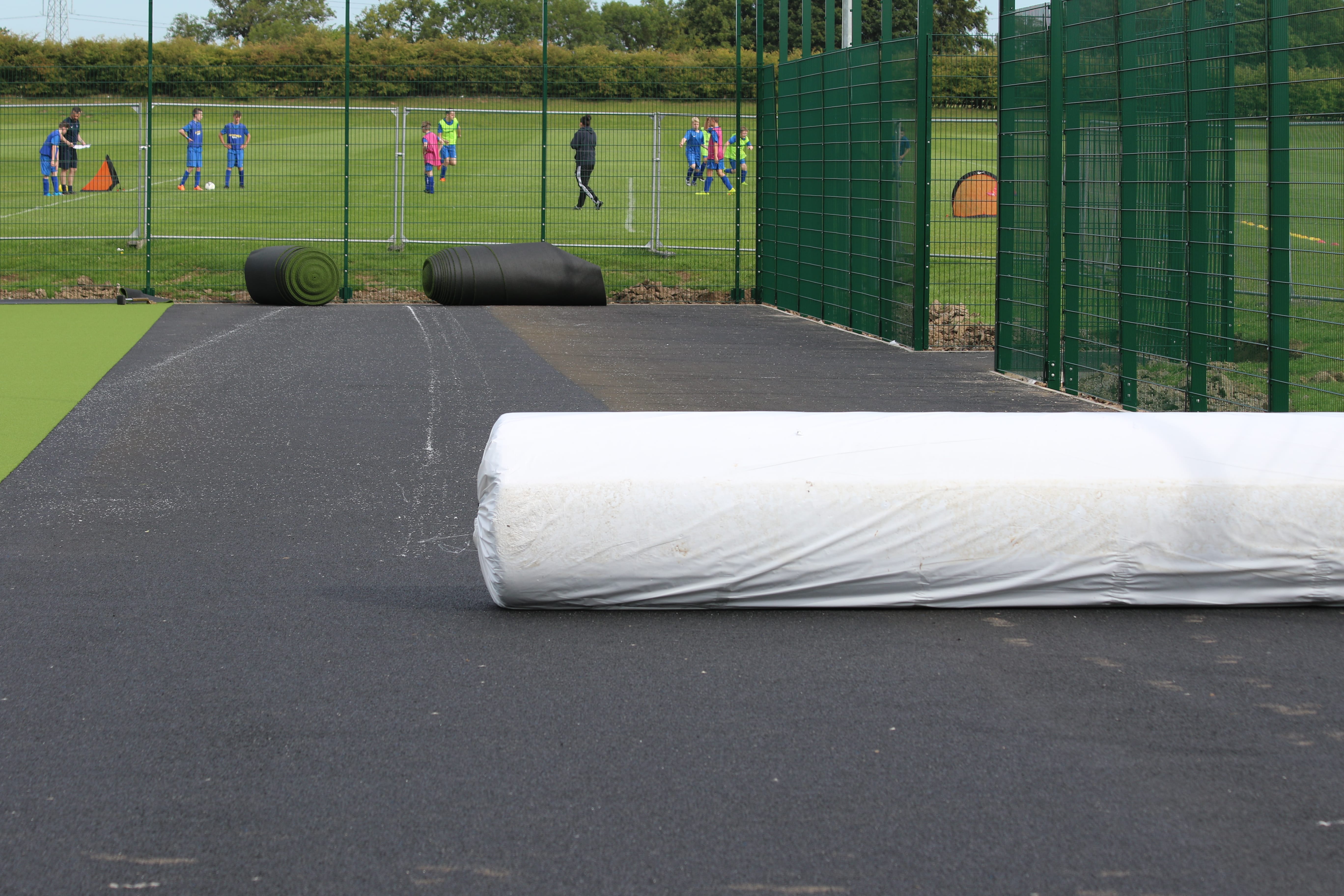 roll of artificial turf transported to surface