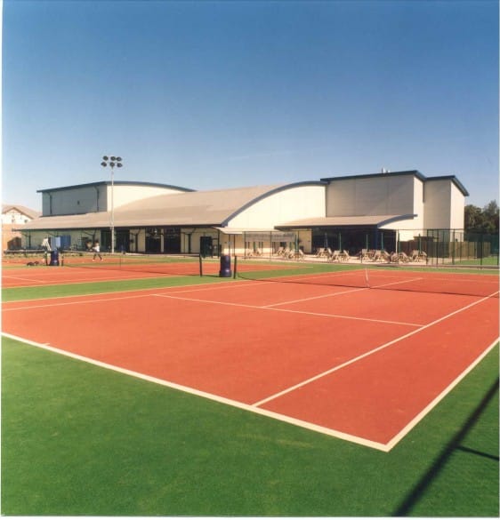 outdoor synthetic tennis surface in green and rust