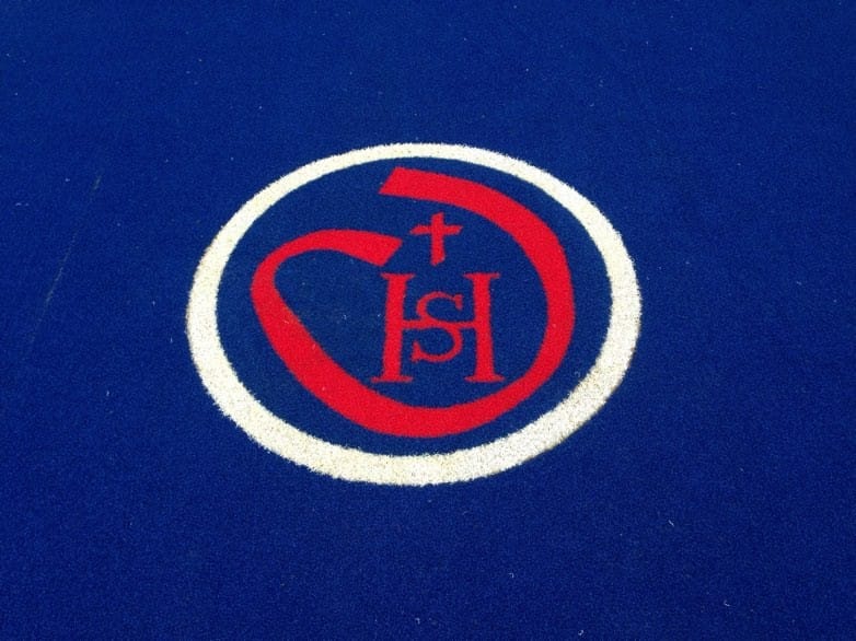 sacred heart school logo in the middle of the muga