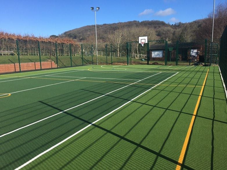 new community muga surrounded by fencing and floodlights