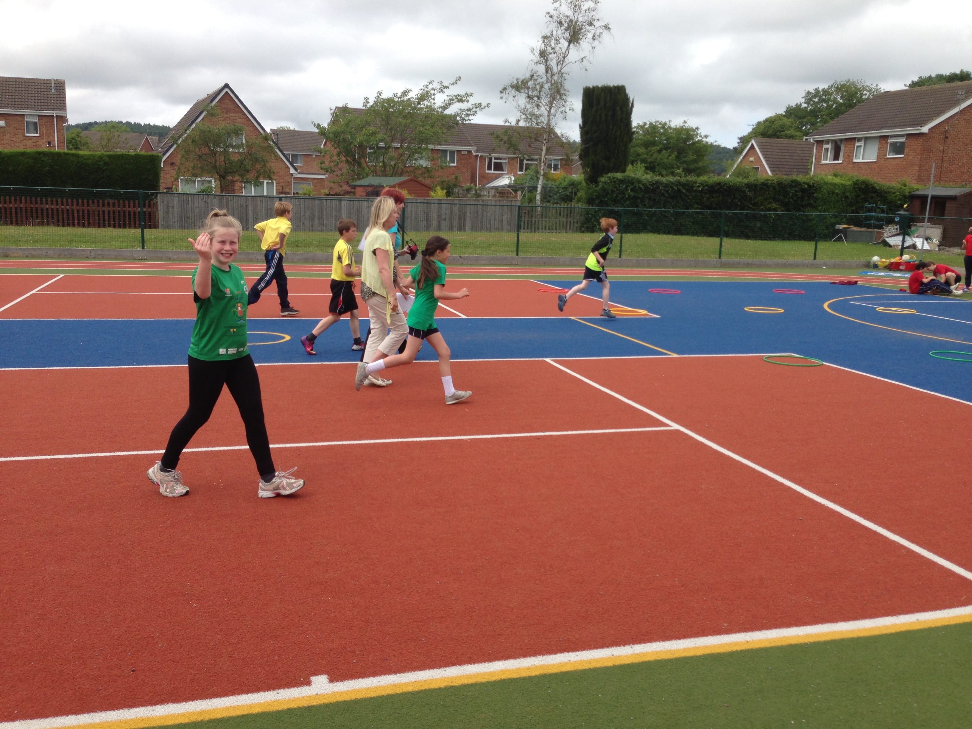 children in pe using artificial grass muga