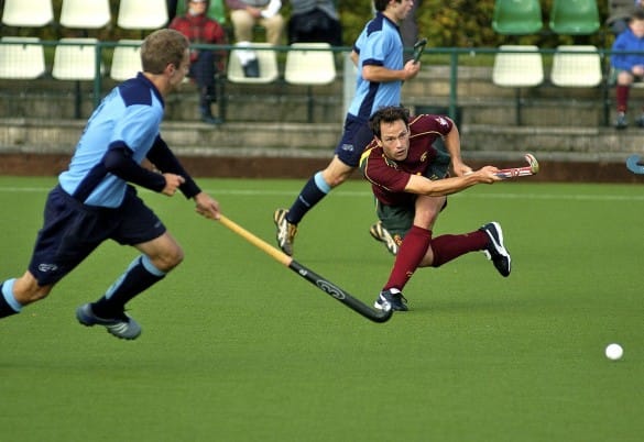 hockey players playing on synthetic turf pitch