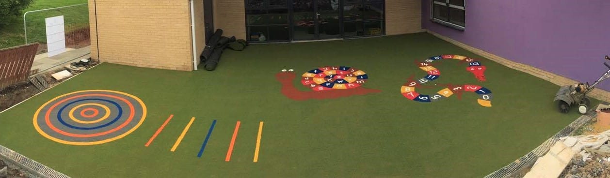 panorama view of green playground with dragon, snail, target and jump line