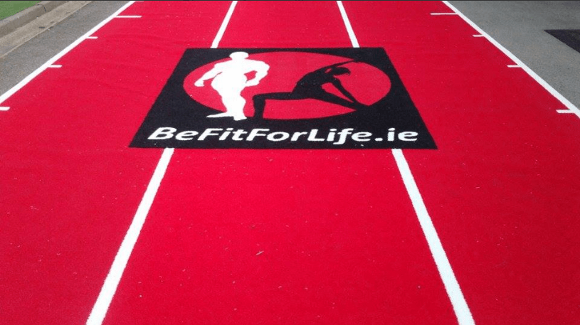 logo mat installed into red gym track