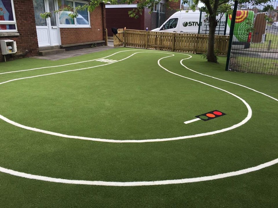 green playground with white roadway markings