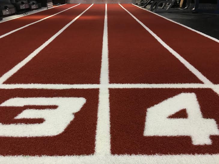 close up view of synthetic turf gym track '3' and '4' number markings
