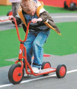 young pupil playing on scooter