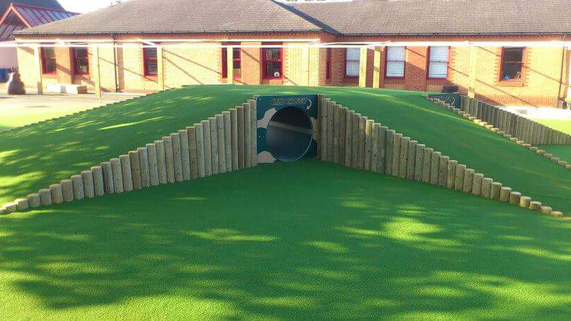 green school landscaping with tunnel