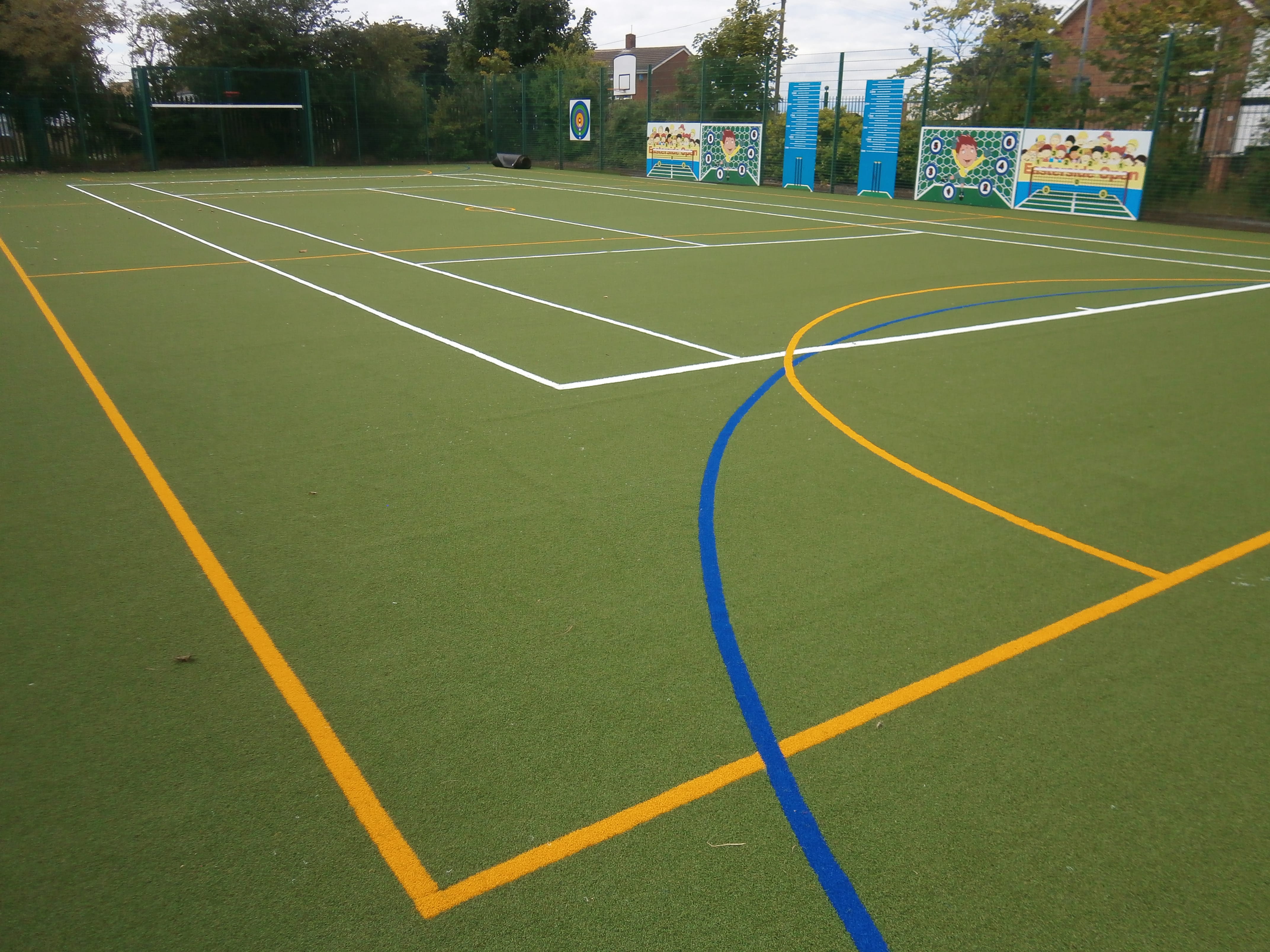 corner view of the school muga showing yellow and blue sport marks