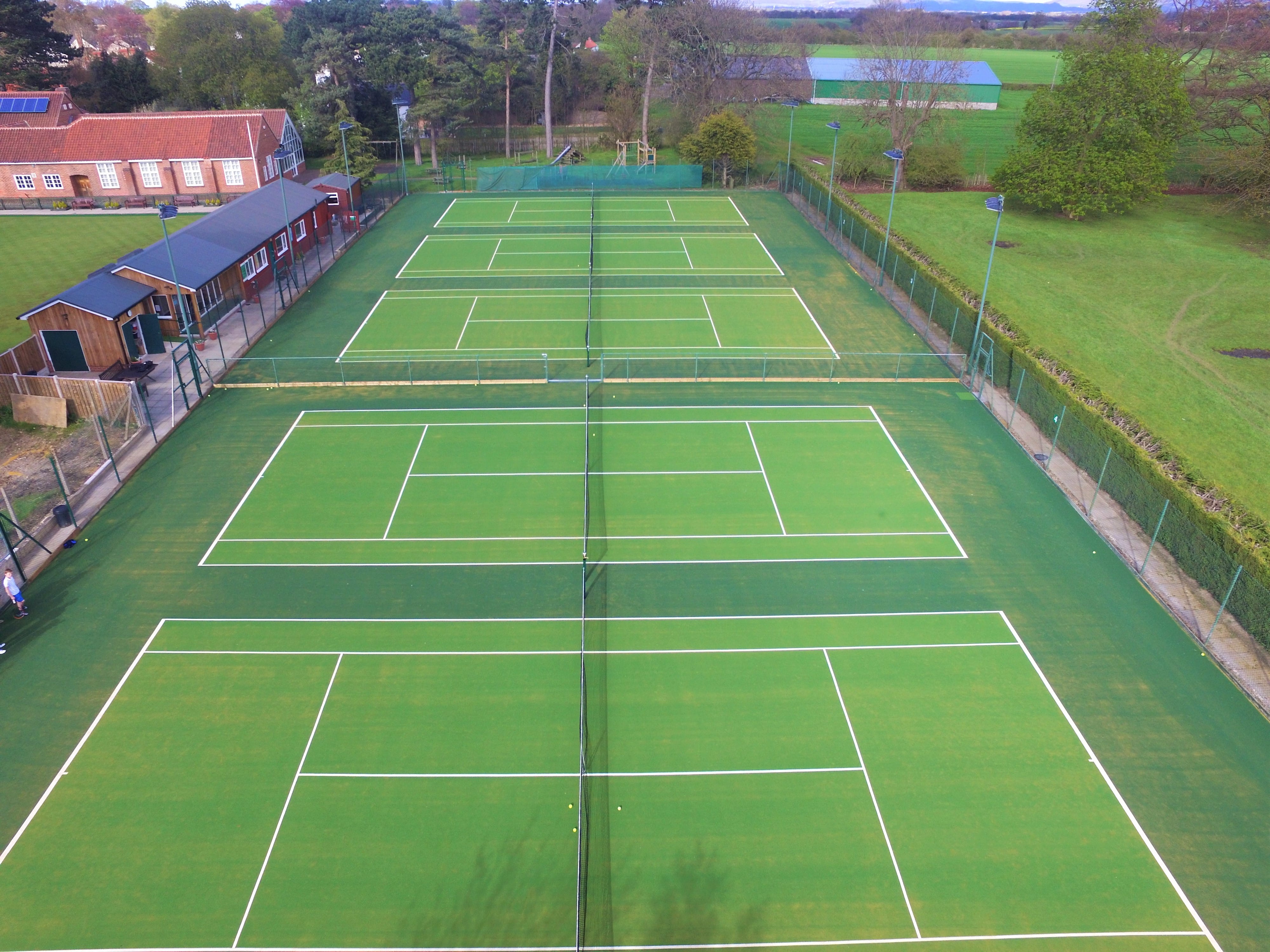 five synthetic turf green tennis courts