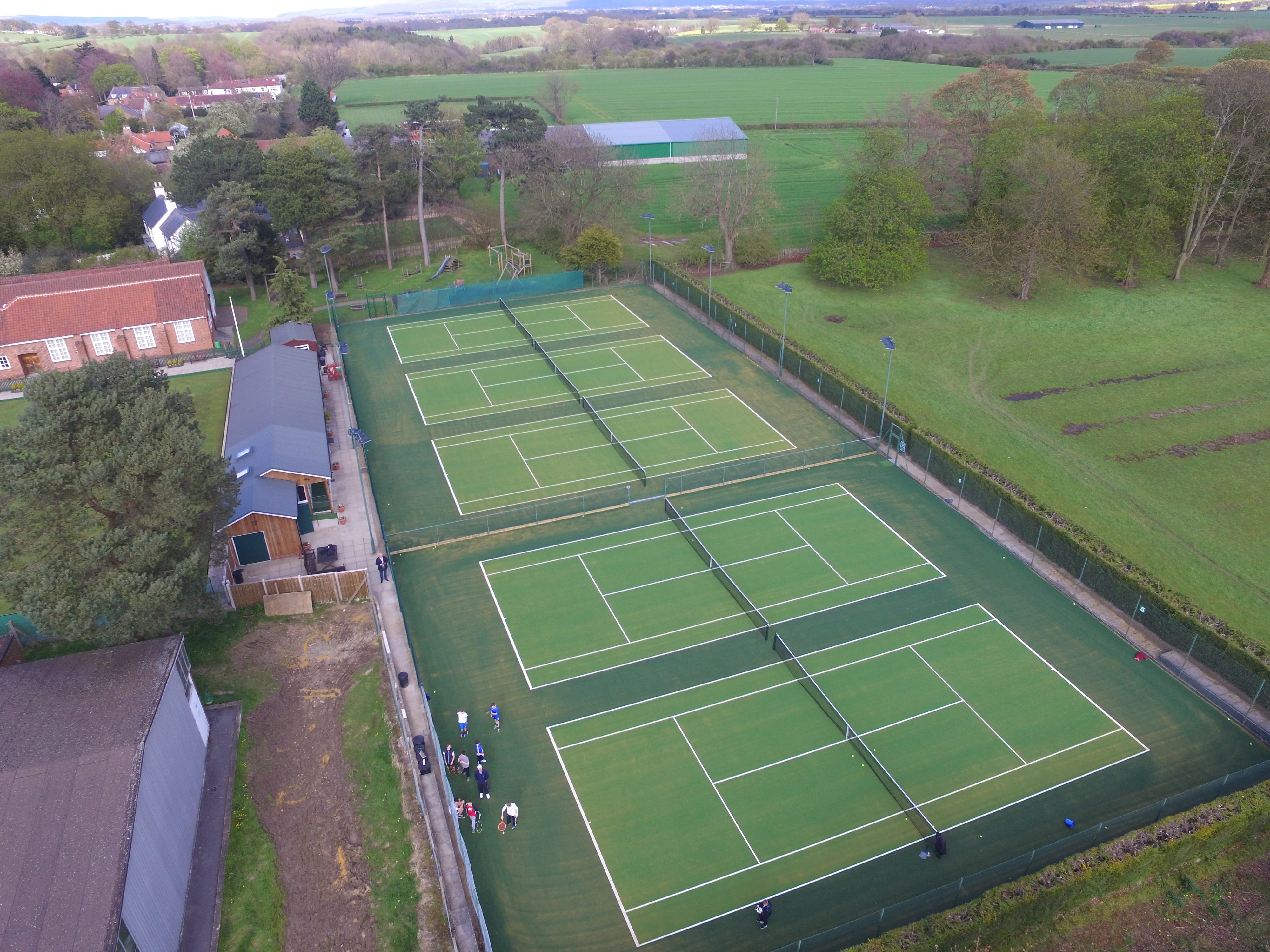 drone view of 5 green tennis courts