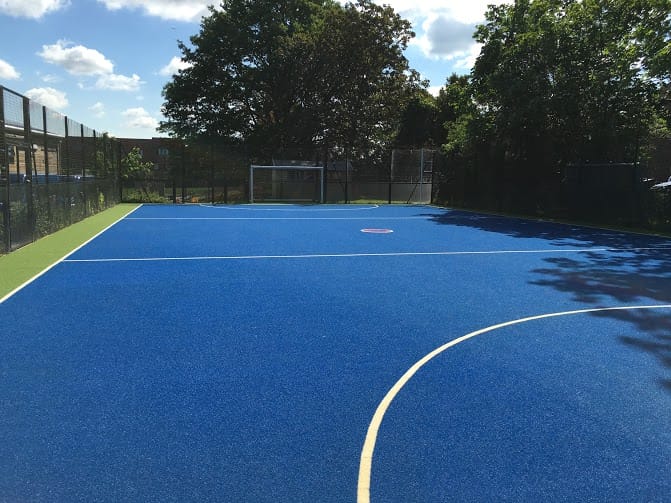 blue secondary school sports surfacing with green border