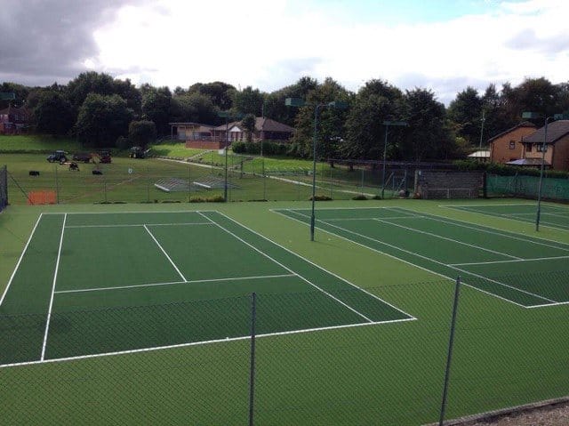 three olive and field green outdoor tennis courts