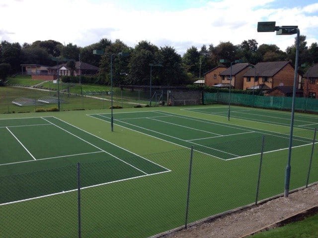 completed installation of tennis courts at Prestwick surrounded by fencing and floodlights