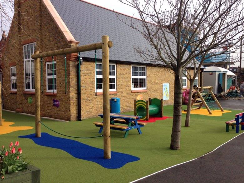 playground with trim trail, picnic benches and synthetic turf surface