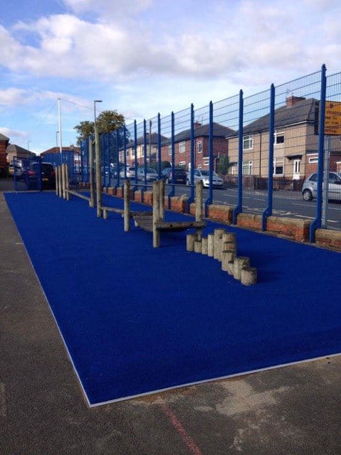 blue artificial turf in replacement of natural grass surface shows clean and tidy play area