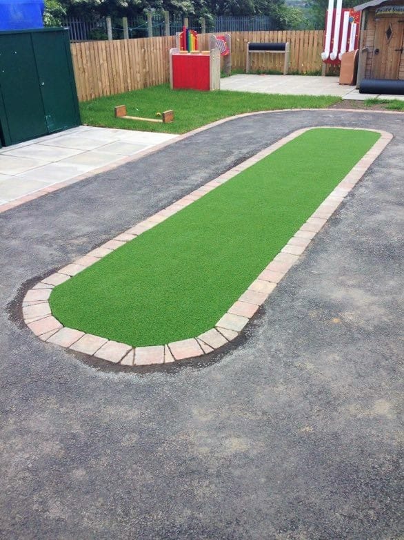 playground roadway with artificial grass middle