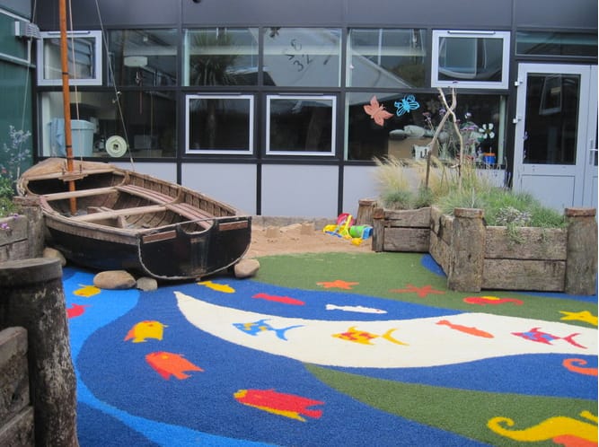 under the sea themed playground with wooden boat and blue surface