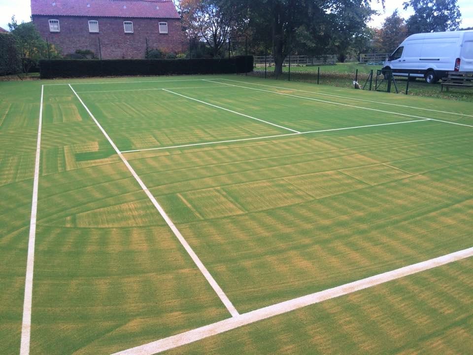 tennis courts during the sand infill process 