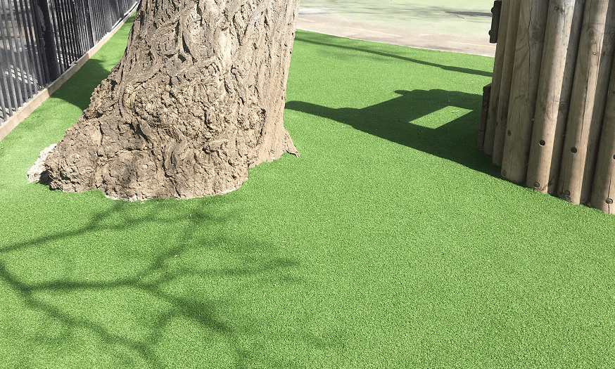 artificial grass cut around a tree