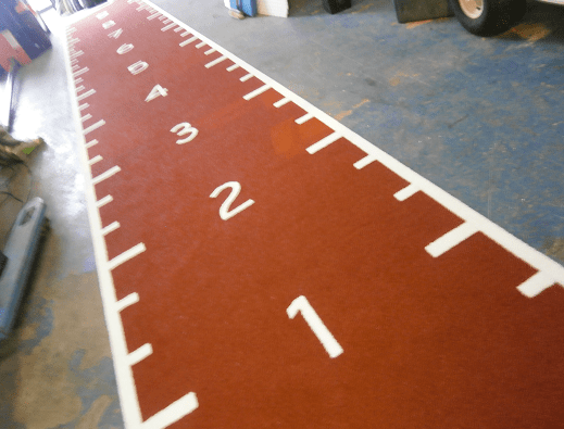 rust gym track with white line markings 1 to 9