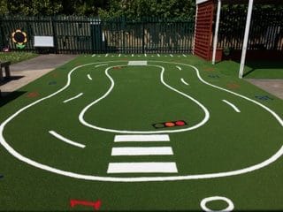 white playground roadway with traffic lights and crossing